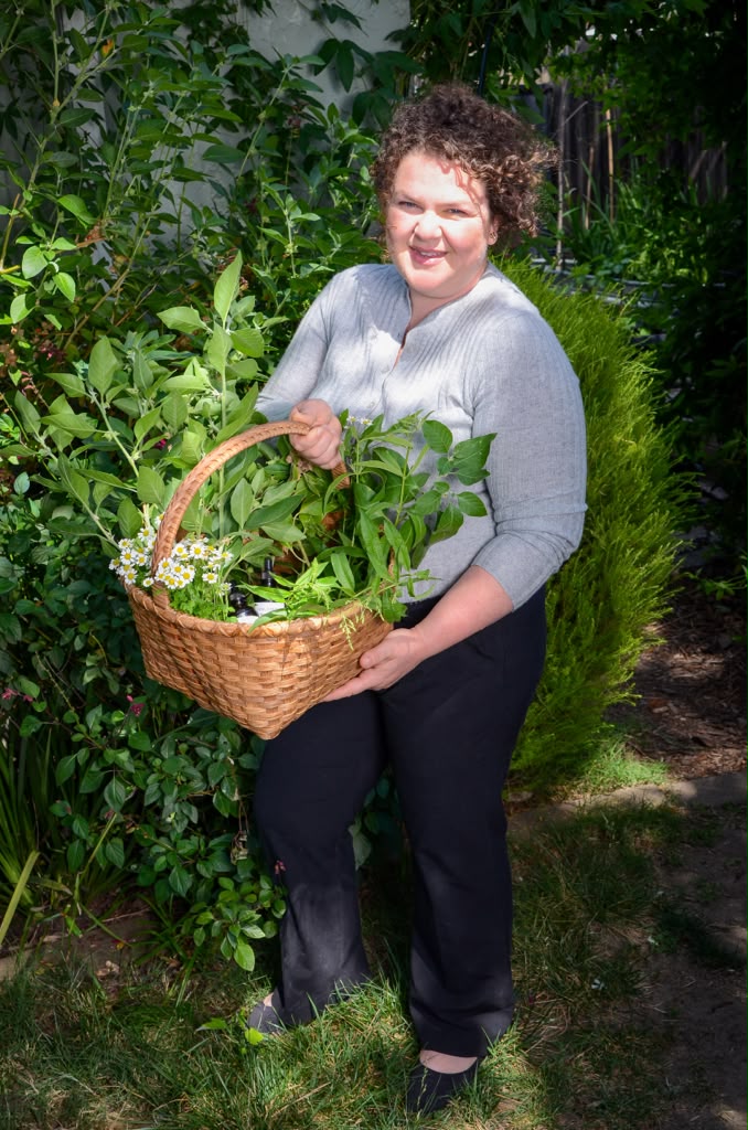 Serena Ling holding a woven basket of freshly gathered herbs
